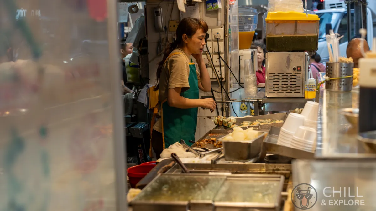 Store attendant selling hong kong street food