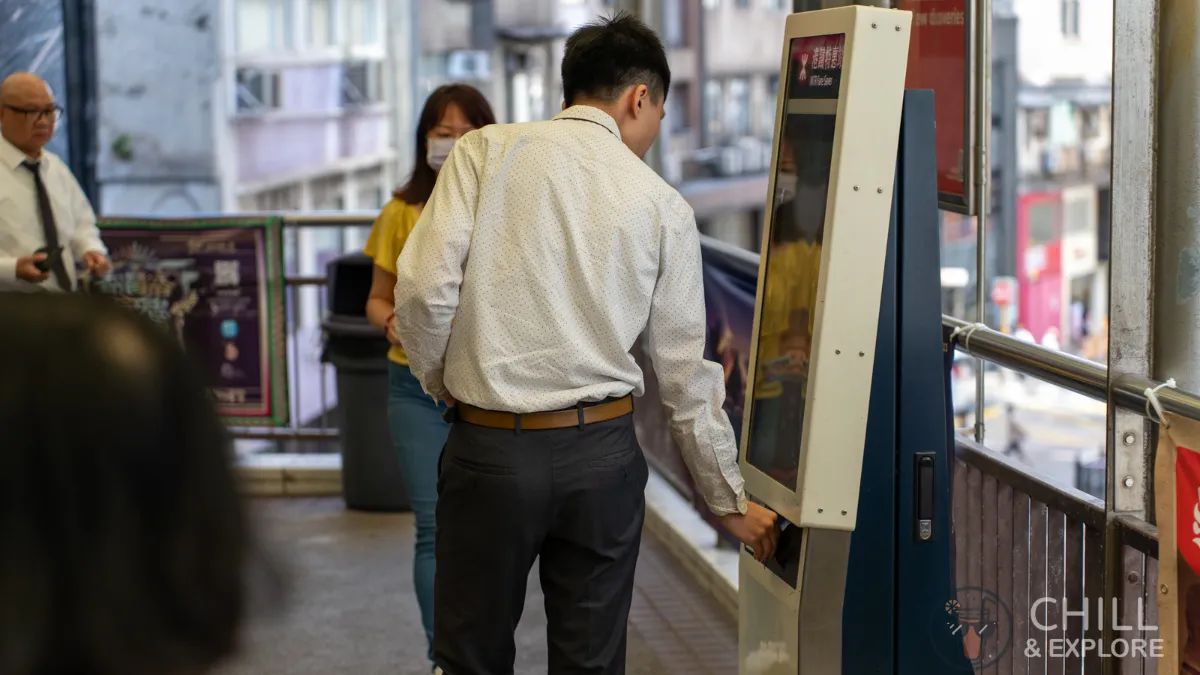 Man tapping octopus on MTR fare saver machine